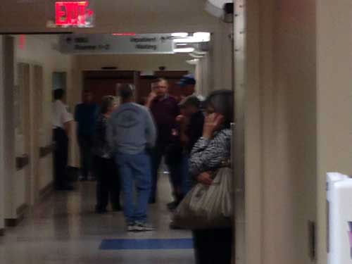 Galveston firefighters stand by in the hallways...